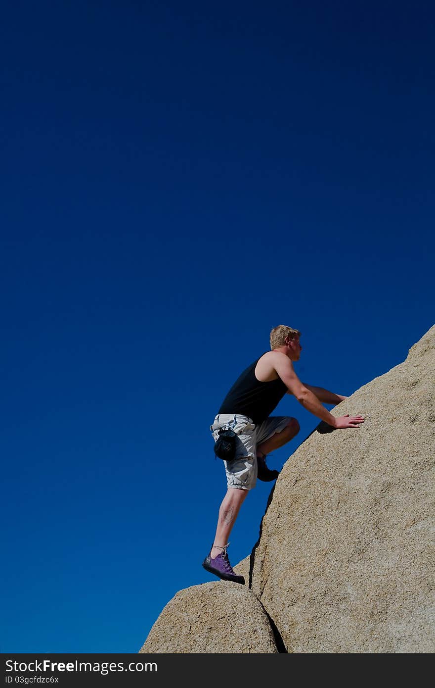 Rock Climber Bouderling at Buttermilk area of Bishop, CA