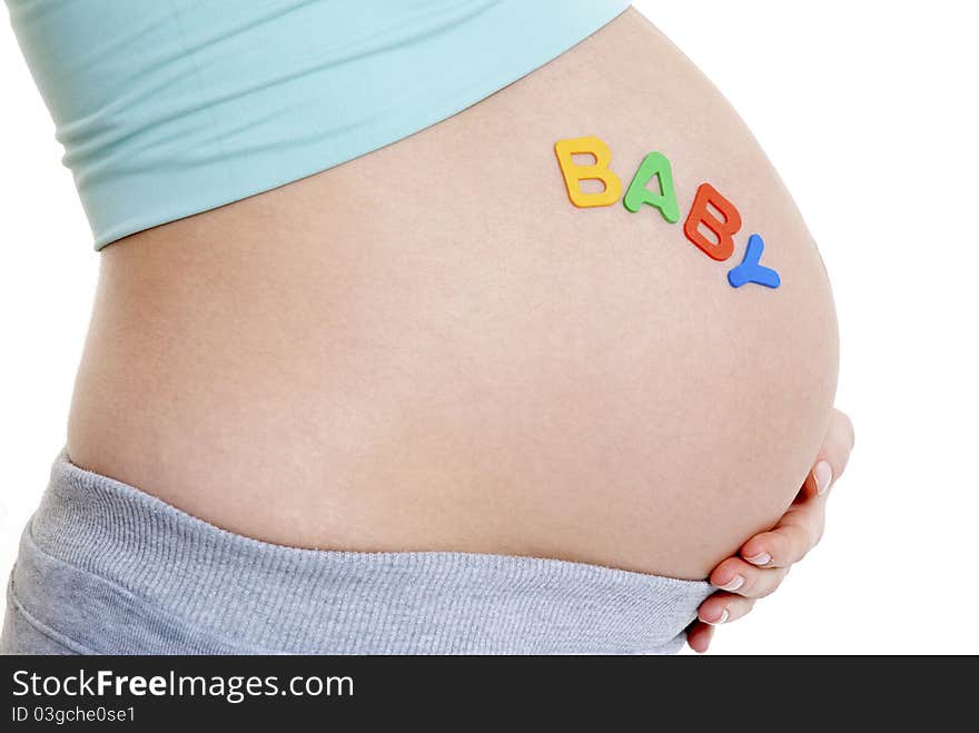 Close up of pregnant ladies tummy- BABY written - landscape. Close up of pregnant ladies tummy- BABY written - landscape