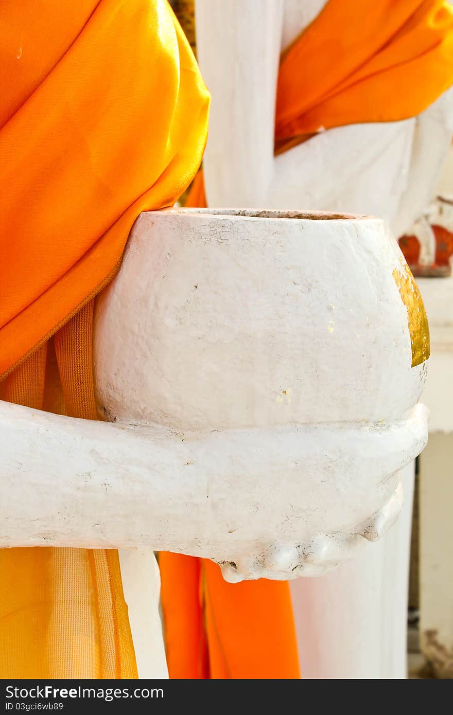 Monk is holding an alms bowl. Monk is holding an alms bowl.