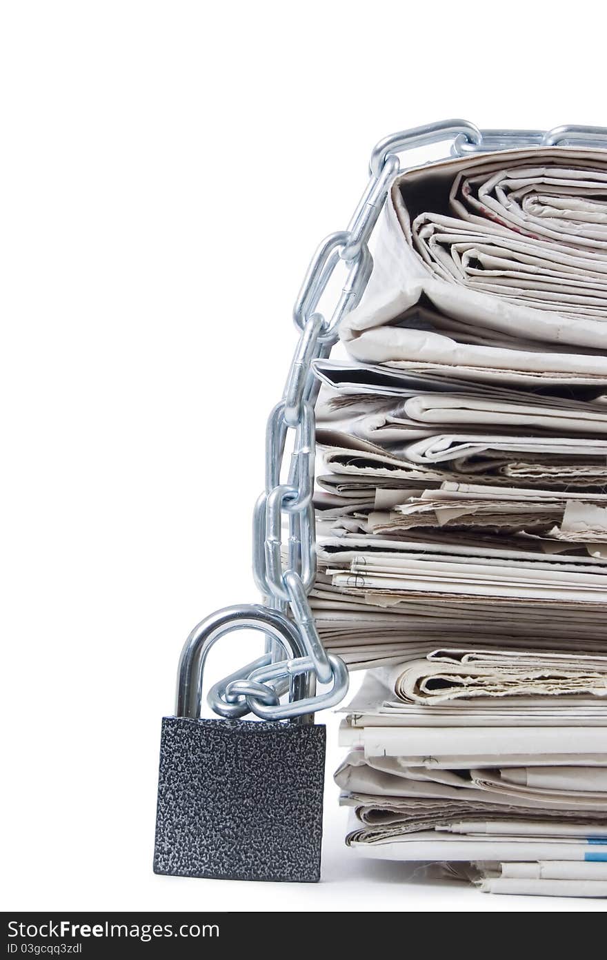 Pile of newspapers with chains on white