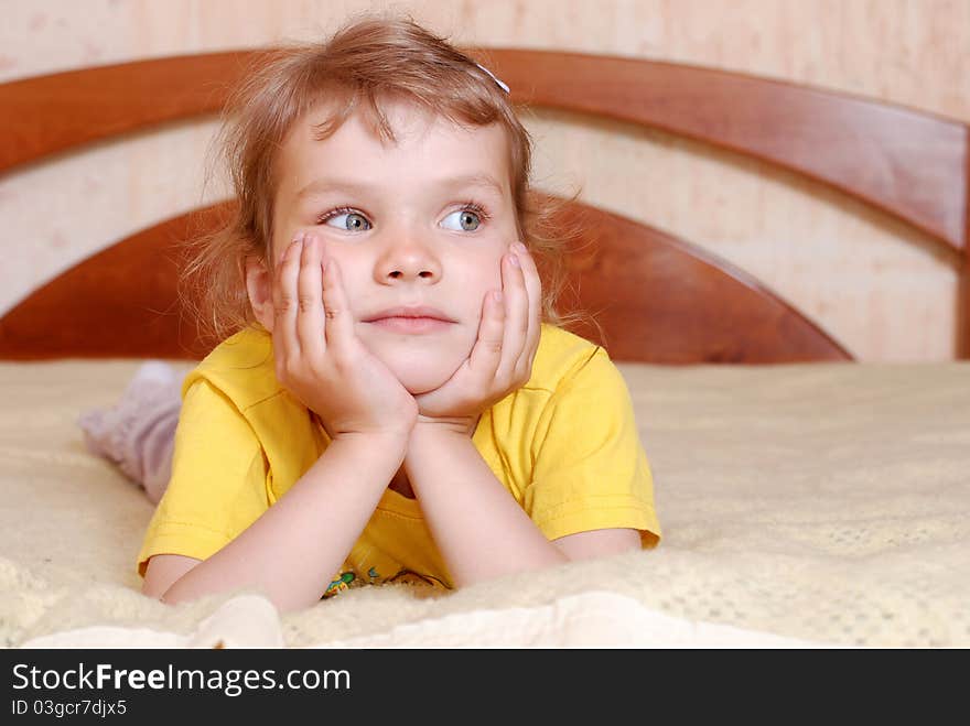 Portrait of a little girl. Young model comes up with a new pose