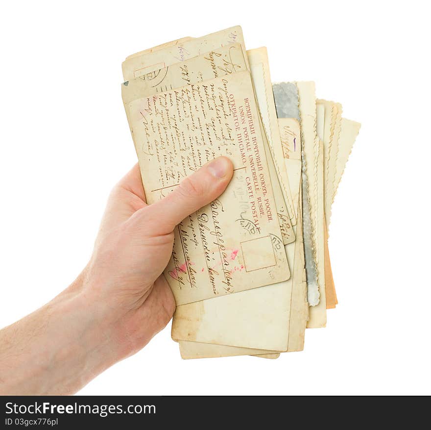 Hand with old handwriting postcard isolated on white