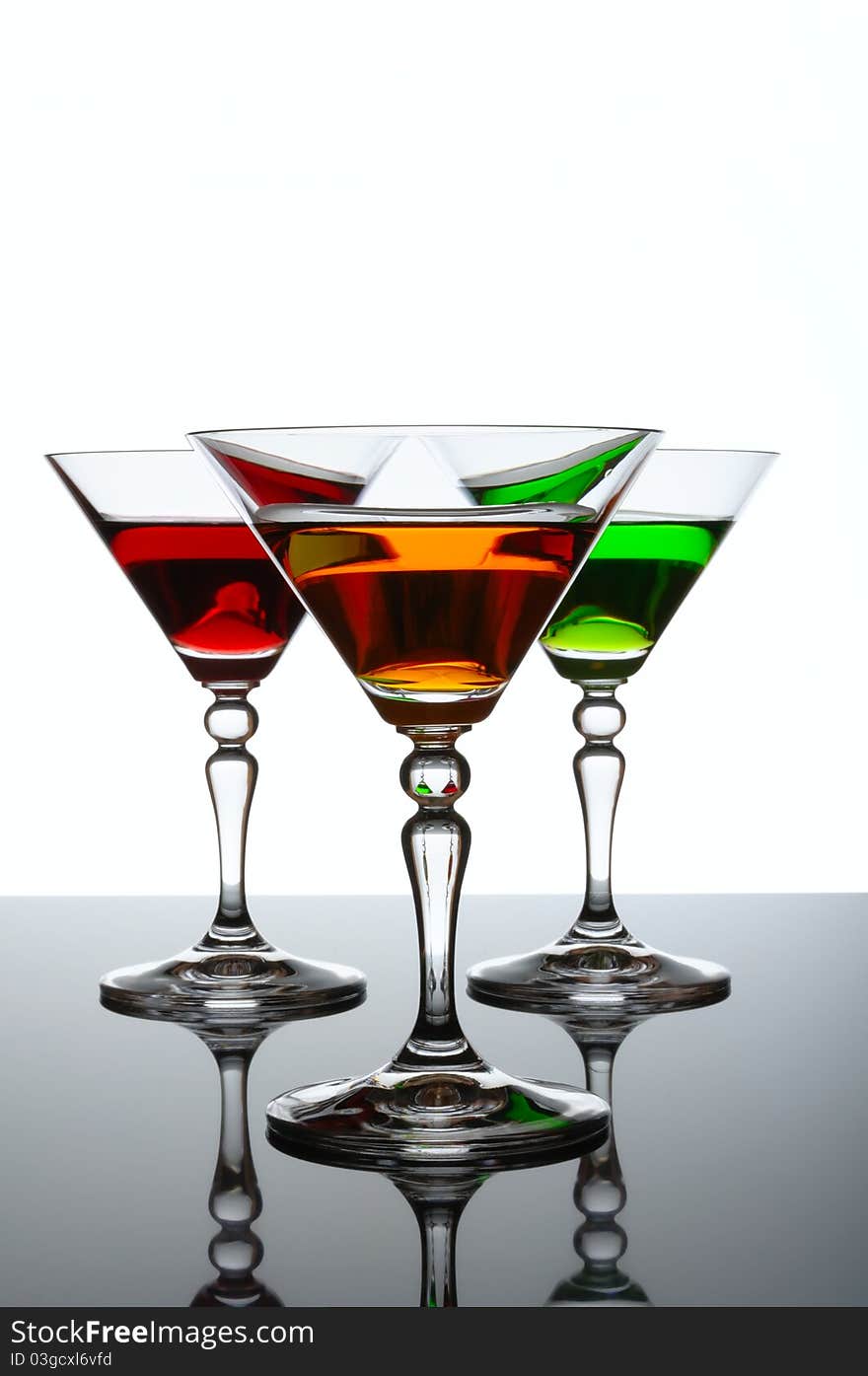 Three glasses of cocktail isolated on white