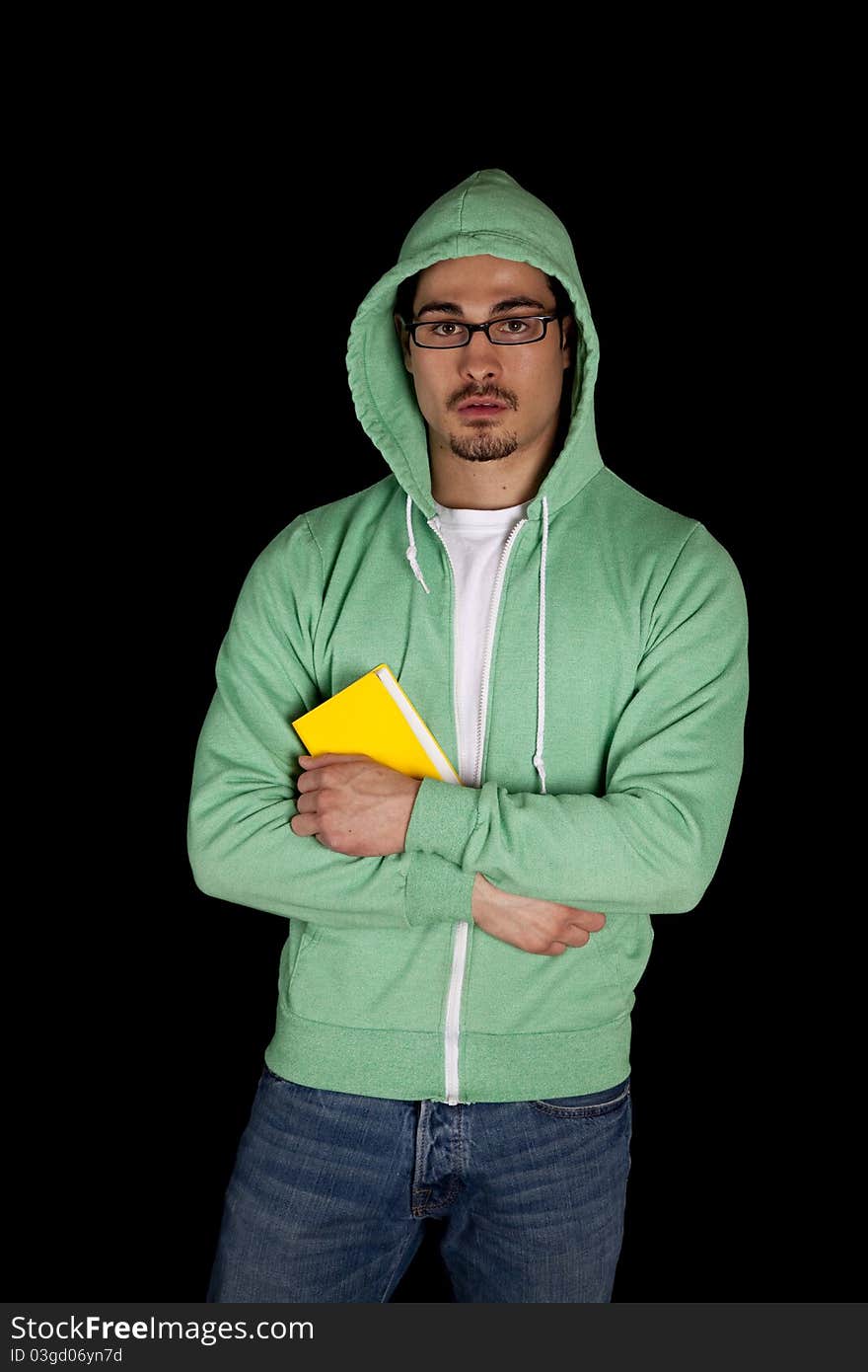 A man is standing with a green book in his arms. A man is standing with a green book in his arms.