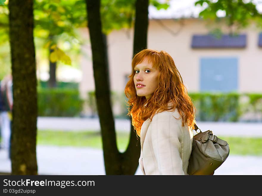 Stylish Girl with red hair for a walk in the park. Stylish Girl with red hair for a walk in the park