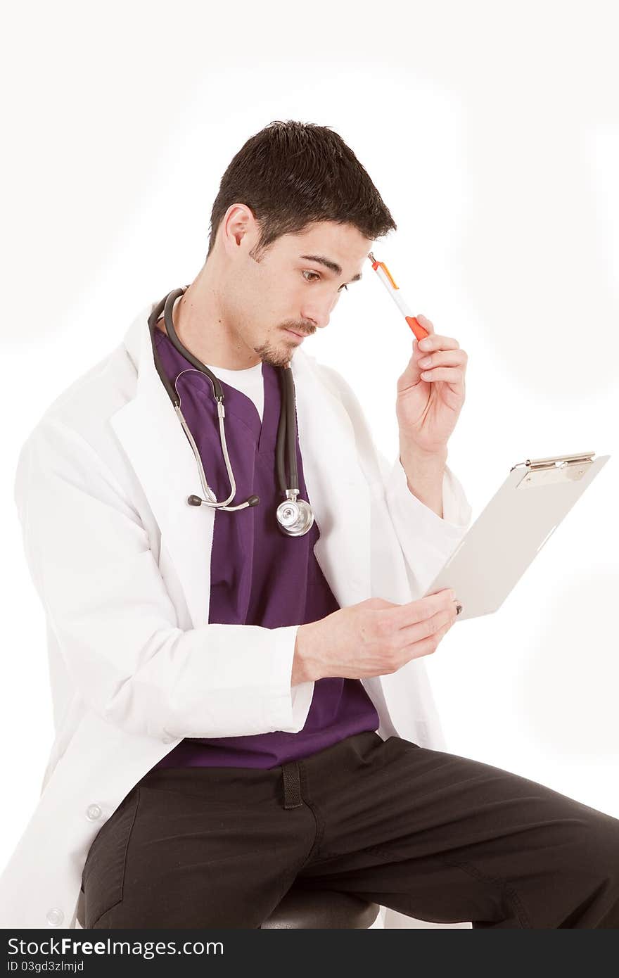 A male doctor is holding a chart and a pen thinking. A male doctor is holding a chart and a pen thinking.