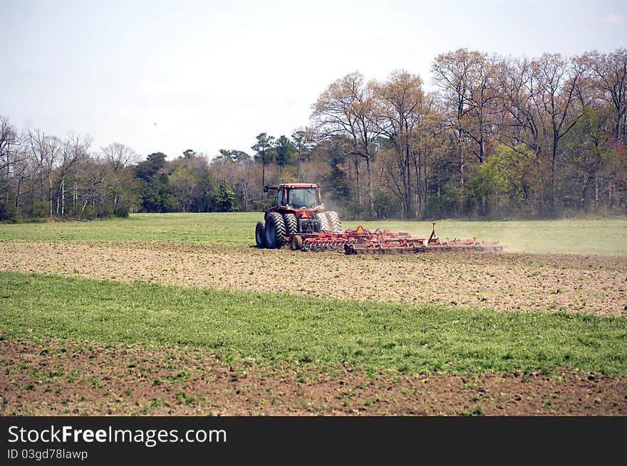 Farmer cultivating field for corn. Farmer cultivating field for corn