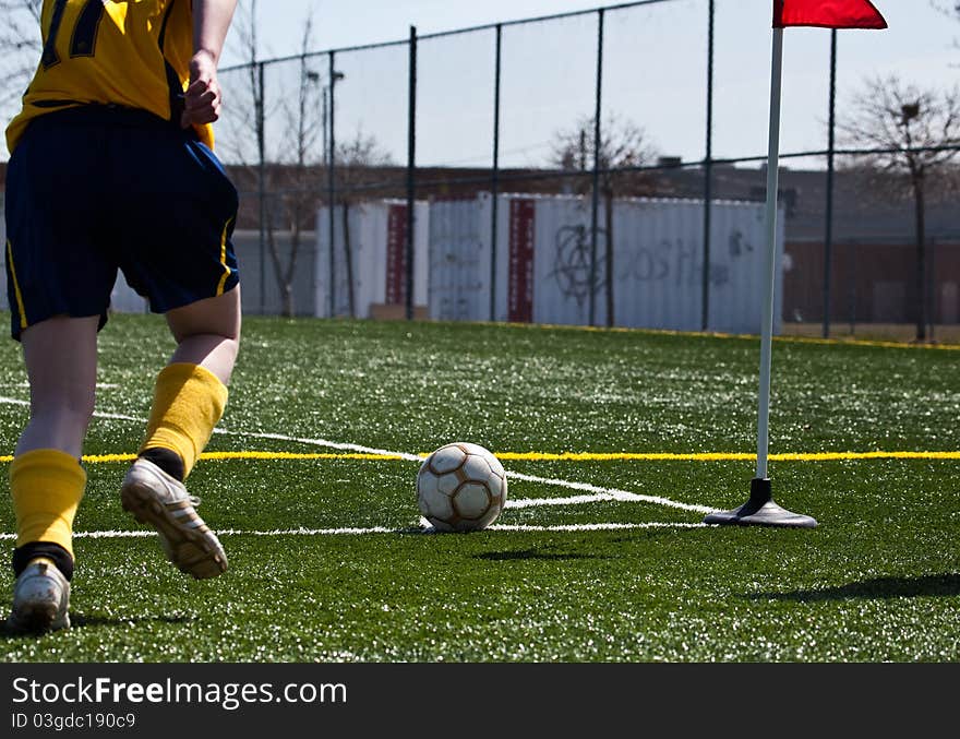 Soccer player kicking ball into play. Soccer player kicking ball into play