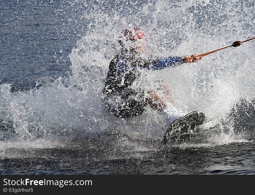 Water skier landing in the water after a jump