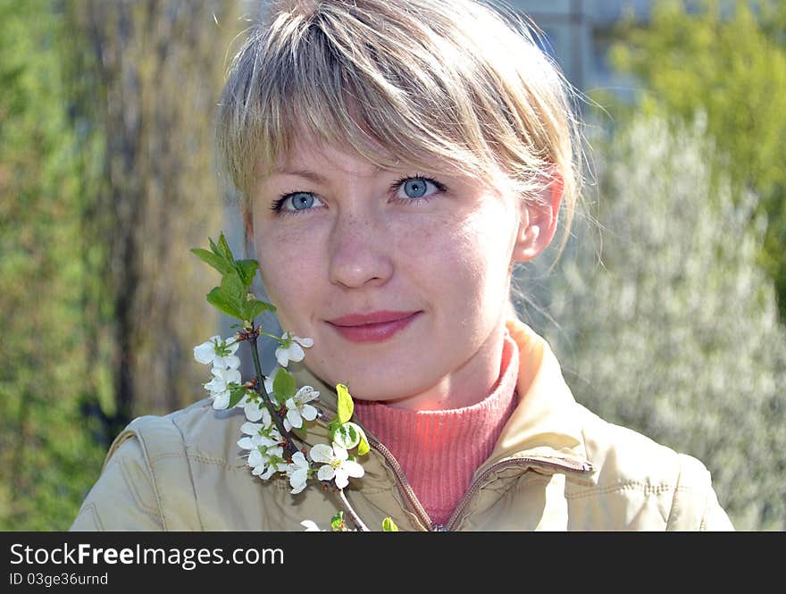 Beautiful girl  on the lawn in spring bloom