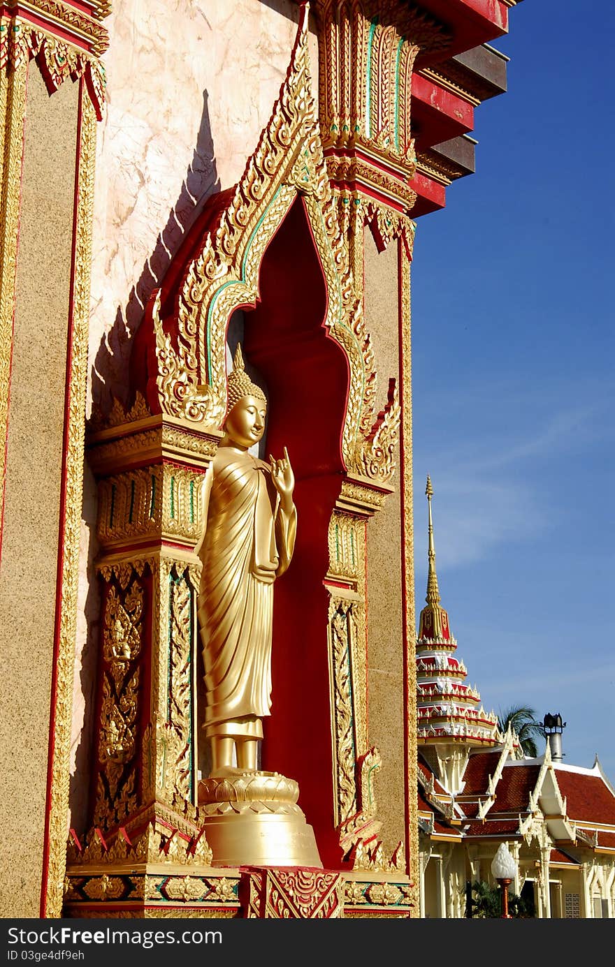 Side wall Buddha church at Phuket on blue sky. Side wall Buddha church at Phuket on blue sky