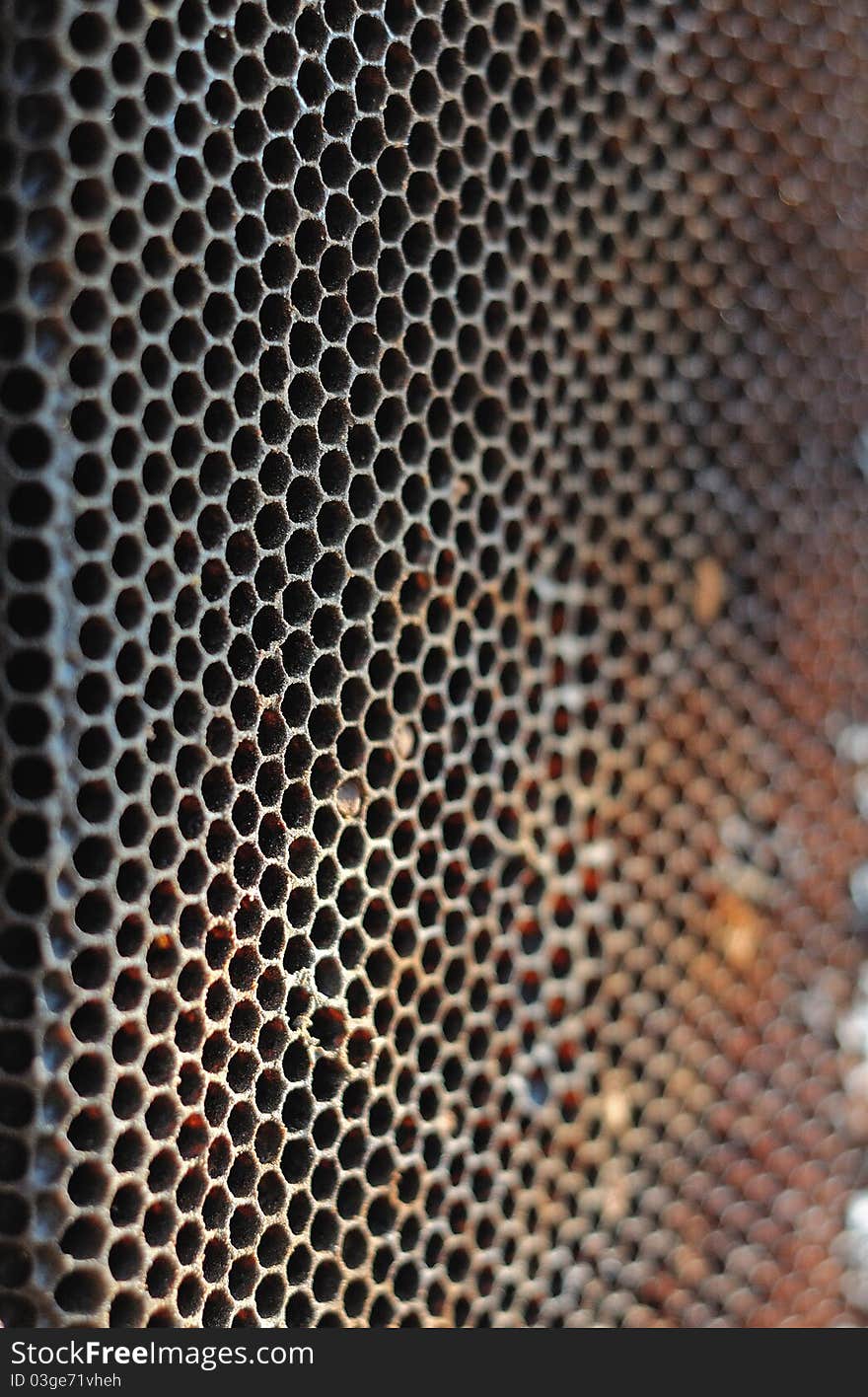 Macro of a partially filled beehive used to produce honey. Macro of a partially filled beehive used to produce honey