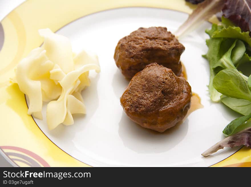 Mincemeat roasted with lettuce leaf onto plates. Mincemeat roasted with lettuce leaf onto plates