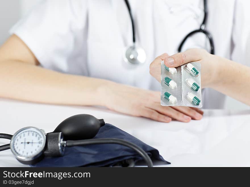 Woman doctor with pills in the hand