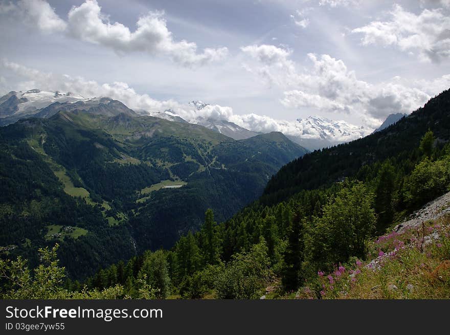 Mountain landscape with snowy peaks, green slopes, pastures,  Switzerland, EU.