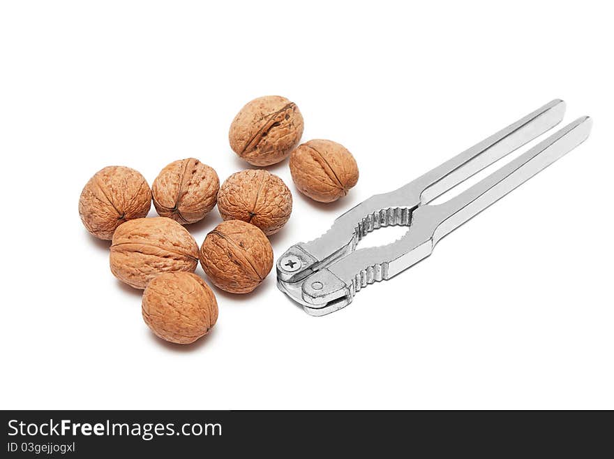 Walnuts and nutcracker isolated on white