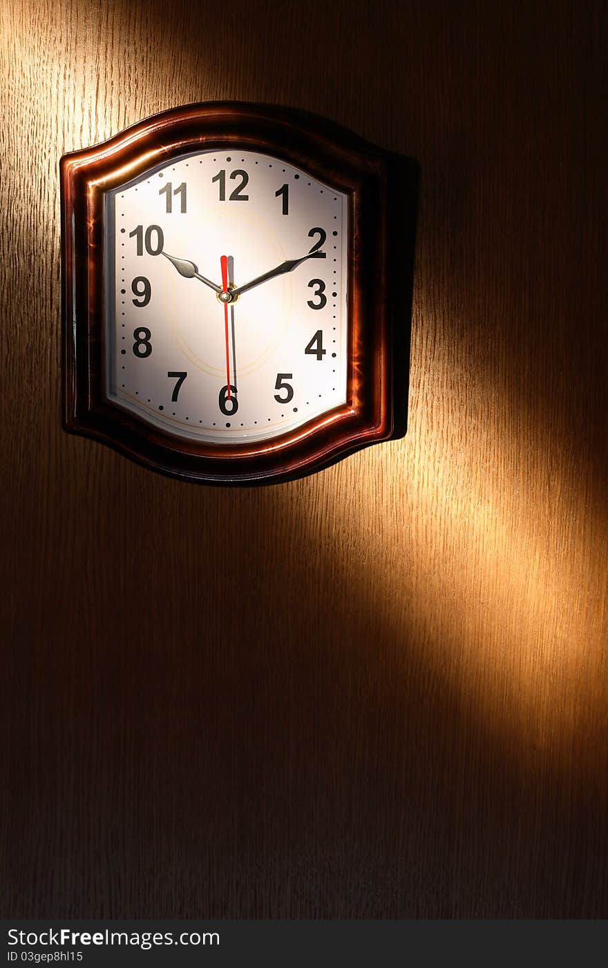 Clock hanging on wooden wall with beam of light. Clock hanging on wooden wall with beam of light