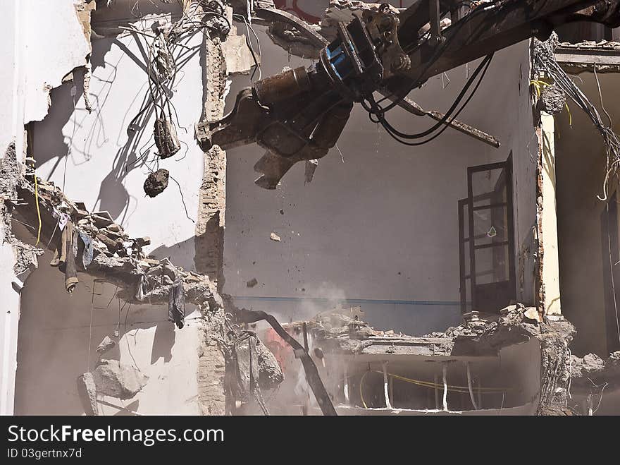 Indrustrial machine demolishing a building