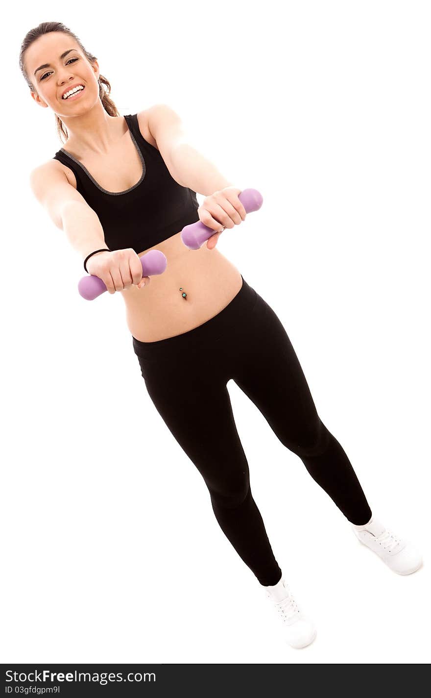 A young female dressed in black gym clothes performing an exercise with hand weights on isloated white backround