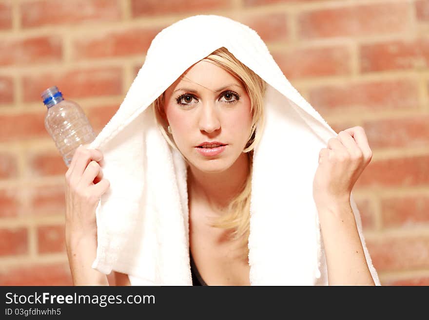 A young female dressed in black gym clothes who has just finished training. A young female dressed in black gym clothes who has just finished training