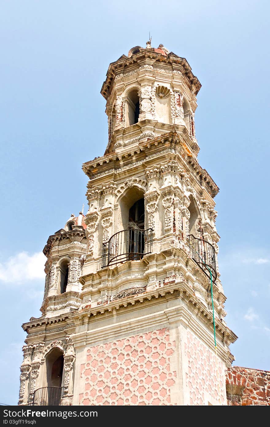 A Catholic church spire rises above the streets of Mexico City.