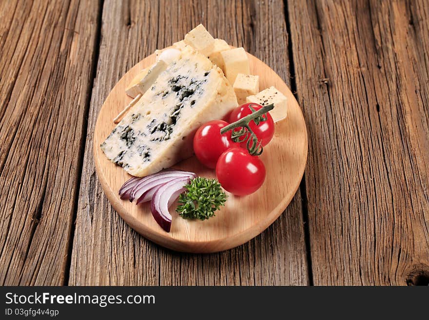 Various types of cheese on cutting board. Various types of cheese on cutting board