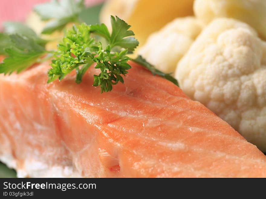 Salmon fillet garnished with fresh parsley - macro