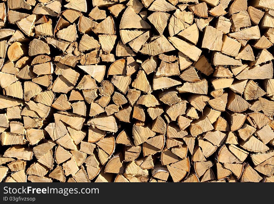 Chopped and stacked pile of pine and birch wood. Texture, background. Chopped and stacked pile of pine and birch wood. Texture, background