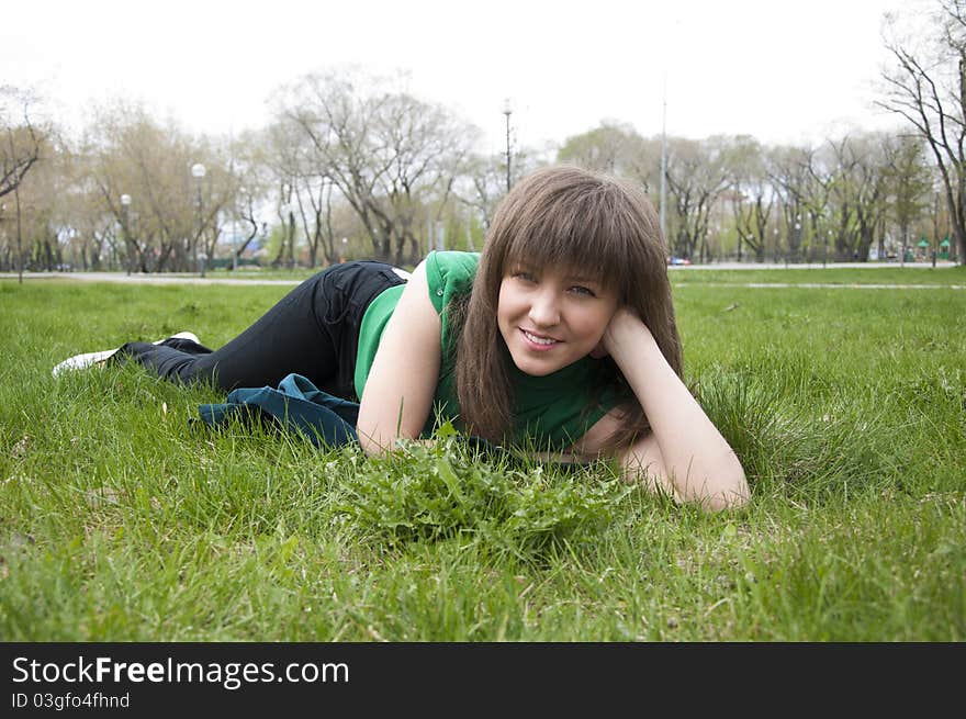 Young Girl Lying On The Grass