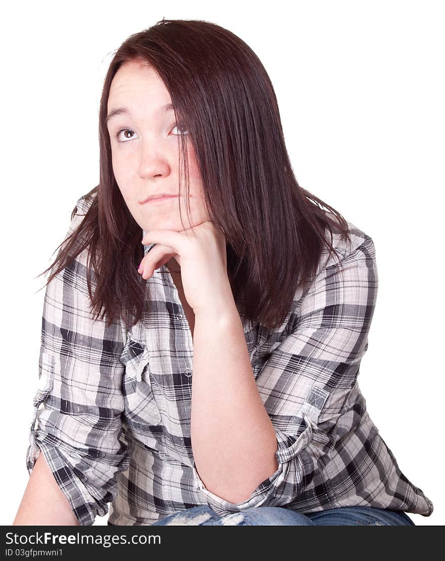 A photograph of a girl isolated sitting with her hand under her chin thinking about life. A photograph of a girl isolated sitting with her hand under her chin thinking about life.