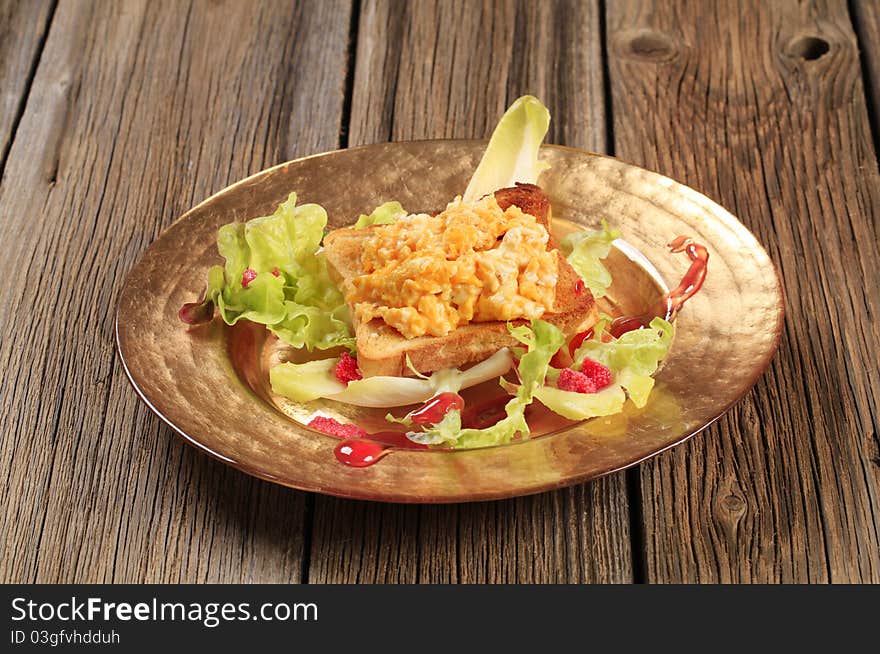 Scrambled Eggs On Toast And Fresh Salad