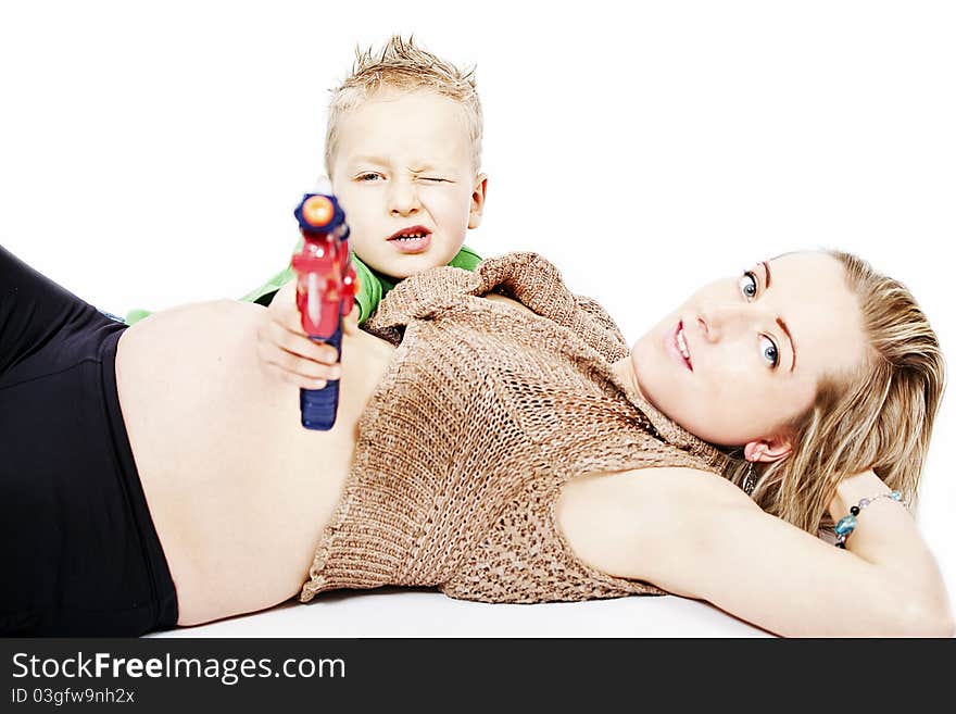 Pregnant mum and her son with toy gun. Pregnant mum and her son with toy gun