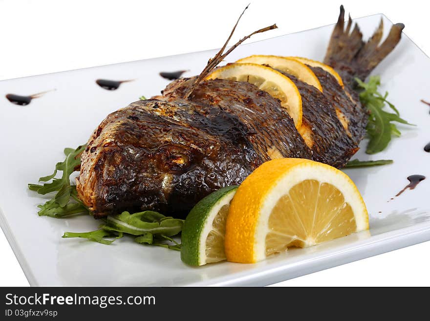 Fried fish with fresh herbs and lemon