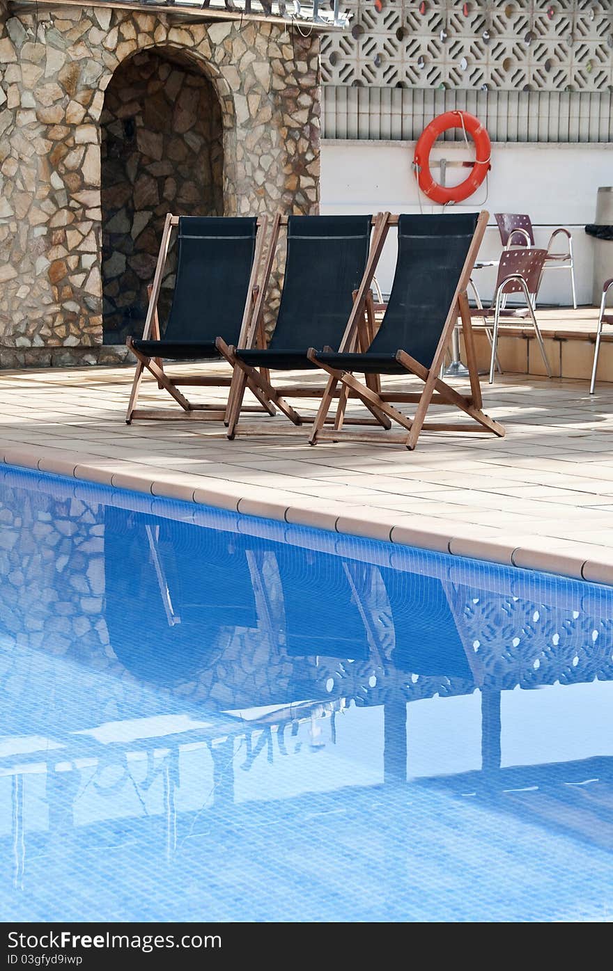 Pool image with beach chairs and palms. Pool image with beach chairs and palms