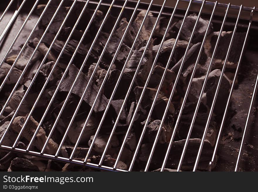 Charcoal under a barbecue grid