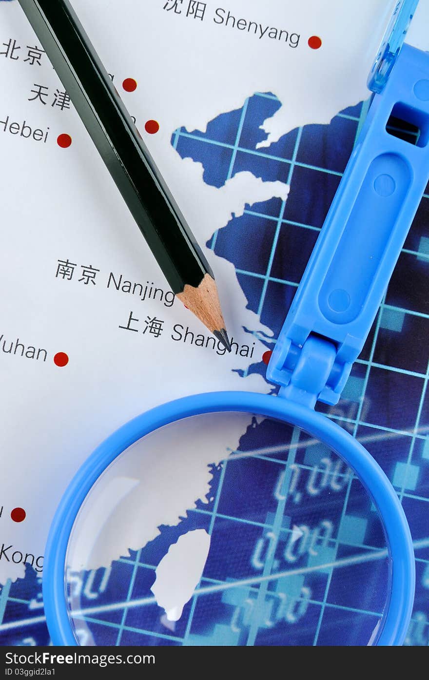 Pencil and magnifier on map, shown as Business or industry developing plan, such as marketing, production, sales quanitity, or related industrial concept. Pencil and magnifier on map, shown as Business or industry developing plan, such as marketing, production, sales quanitity, or related industrial concept.