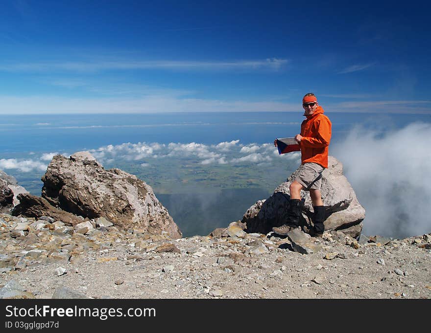 Hiker on Mount Taranaki summit, New Zealand. Hiker on Mount Taranaki summit, New Zealand