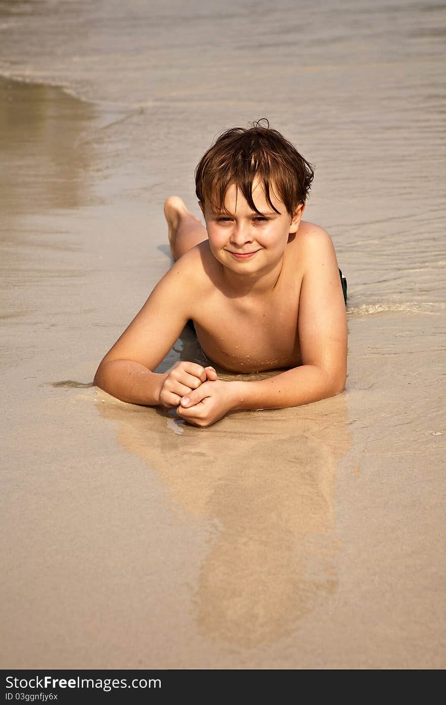 Boy iy lying at the beach