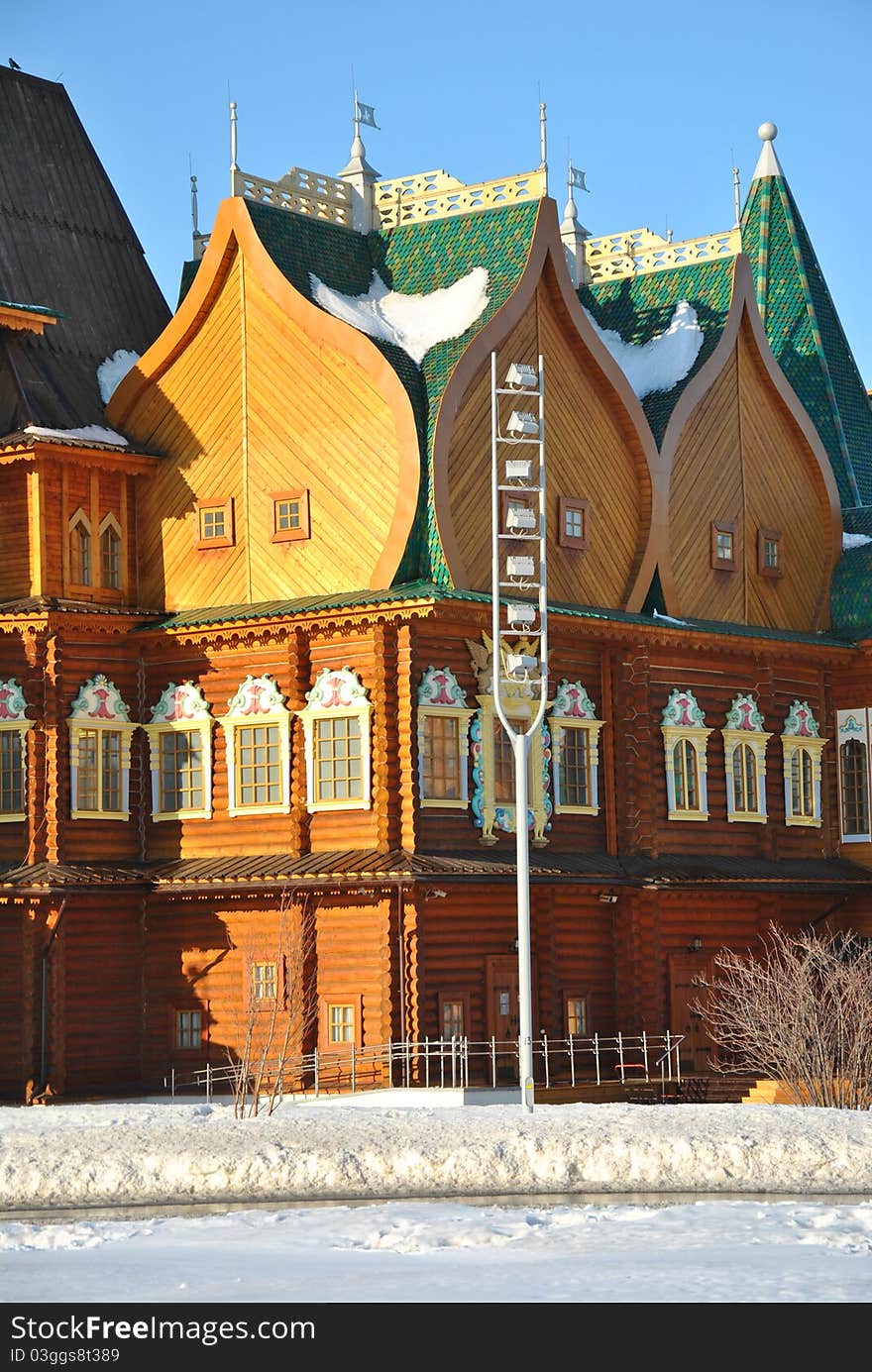 Wooden palace of Tsar Alexei Mikhailovich in Moscow in traditional Russian style at the background of a winter park. Wooden palace of Tsar Alexei Mikhailovich in Moscow in traditional Russian style at the background of a winter park.