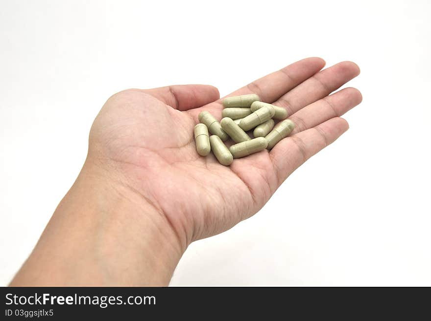 Medicine in a hand on white background