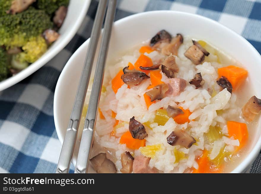 Asian style healthy mixed vegetable porridge in white bowl. Asian style healthy mixed vegetable porridge in white bowl.