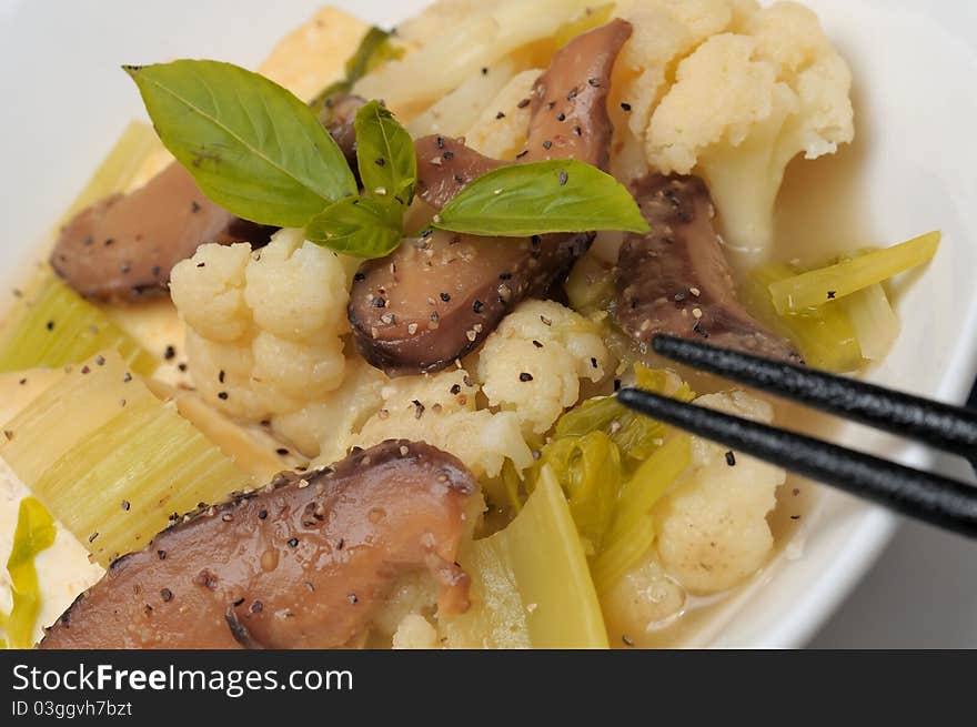 Healthy white cauliflower and mushroom delicacy topped with black pepper. Healthy white cauliflower and mushroom delicacy topped with black pepper.