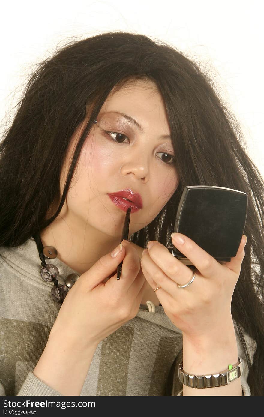 Woman applying makeup