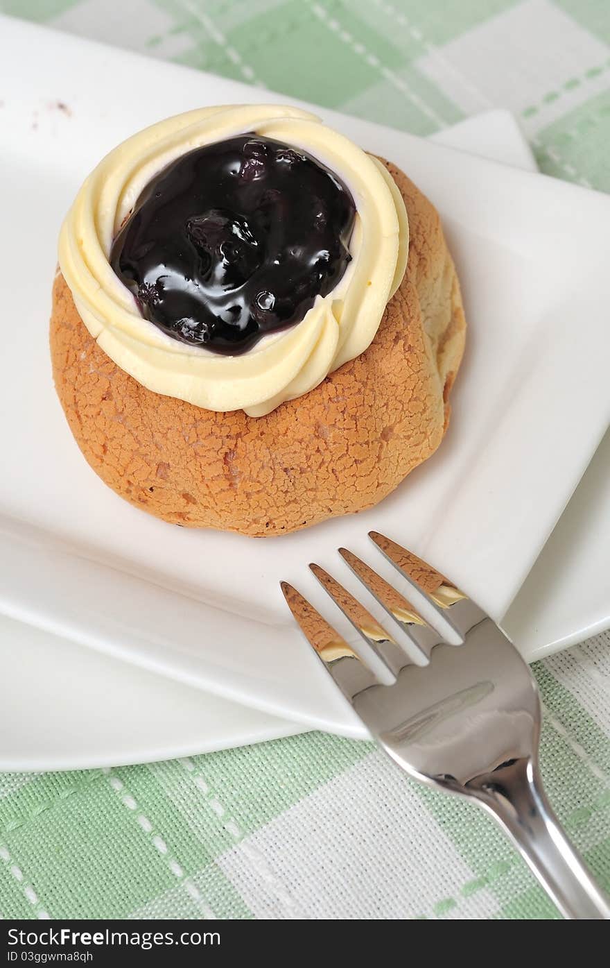 Delicious blueberry cream bread on white plate. Delicious blueberry cream bread on white plate.