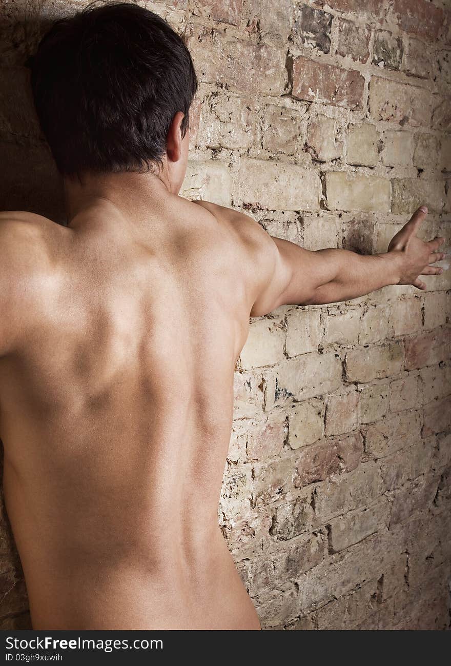 Man is posing near wall