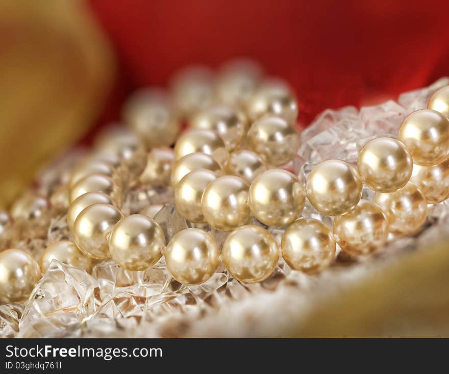 Elegant pearls over ice with ribbon very shallow depth of field