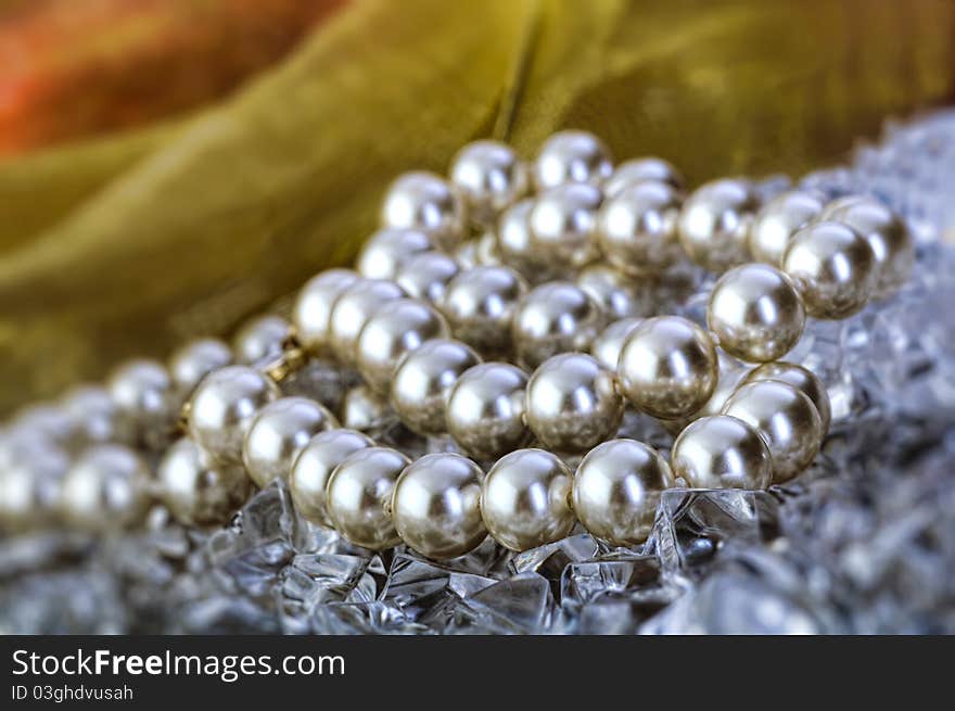 Elegant pearls over ice with ribbon very shallow depth of field