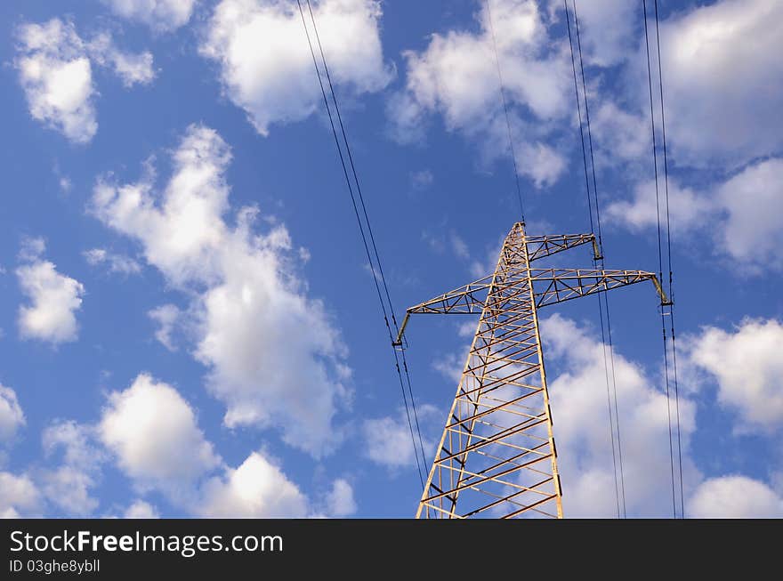 High-voltage electricity wires and poles in the background of clouds. High-voltage electricity wires and poles in the background of clouds.