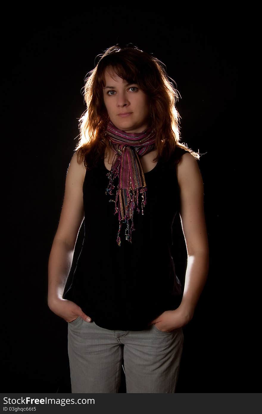 Woman portrait with pink scarf on black background