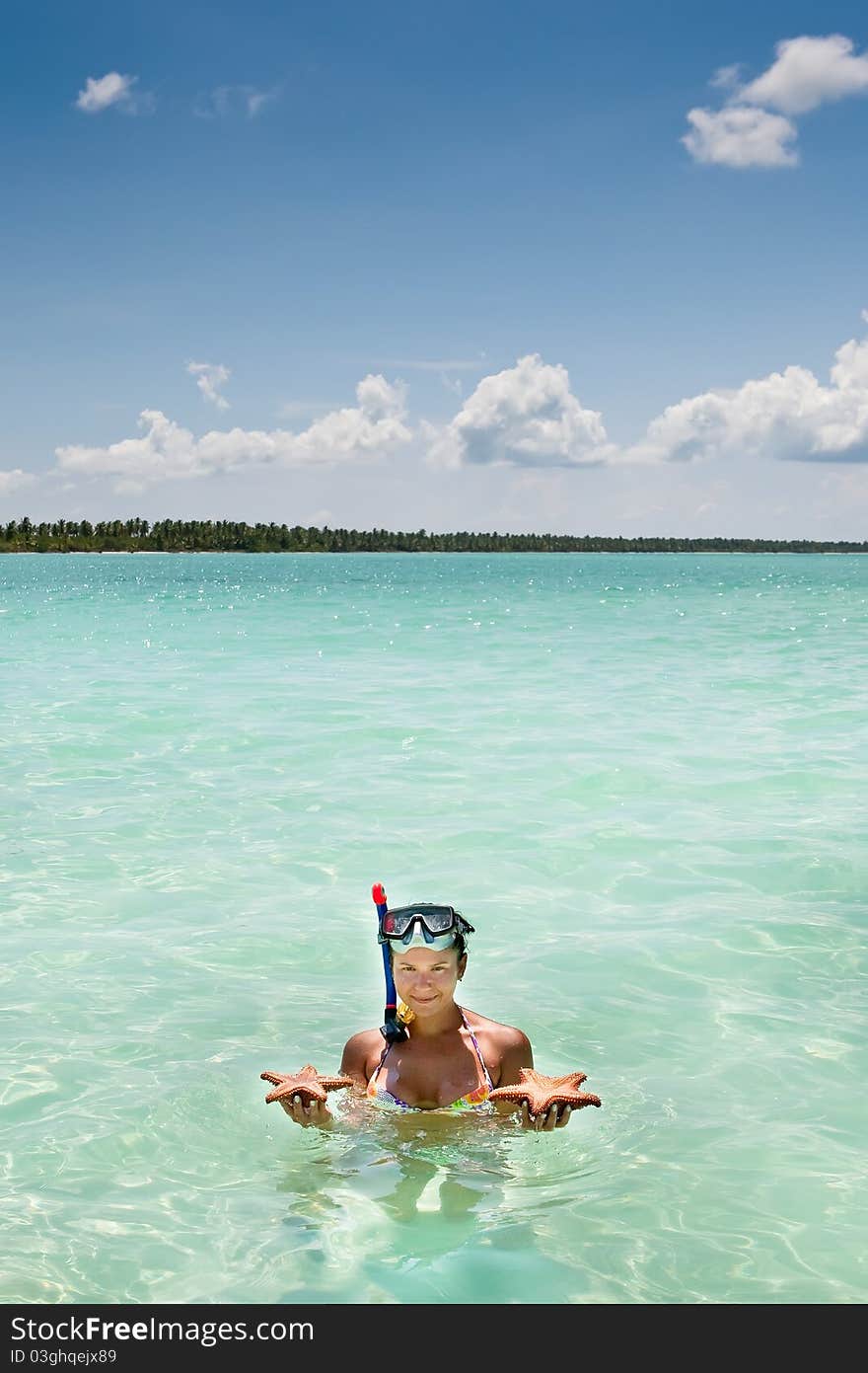 Tanned Women Hold In Hands Starfish Ocean